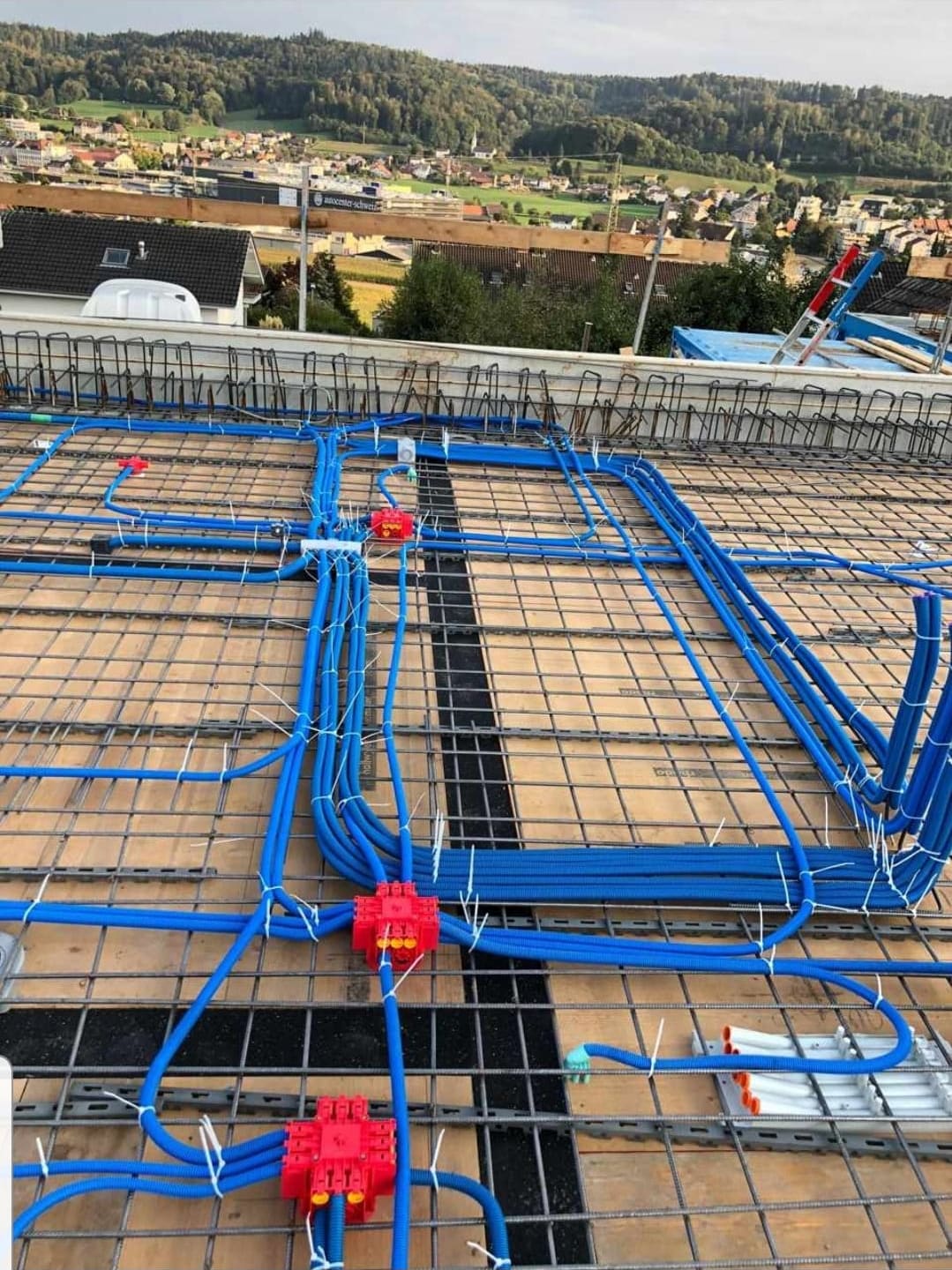 Blaue Elektrorohre auf der Armierung einer Betondecke